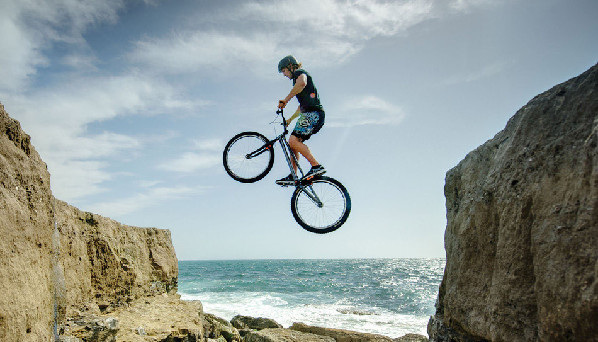极限自行车者不惧生死 飞跃海岛巨石脚下惊涛骇浪图片频道 - 海口网 - 海口权威新闻门户网站